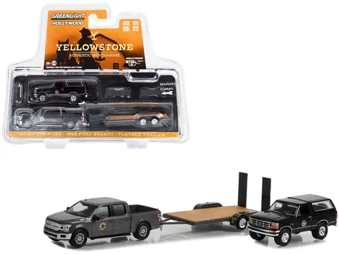 2018 FORD F-150 PICKUP TRUCK GRAY WITH 1992 FORD BRONCO "MONTANA LIVESTOCK ASSOCIATION" BLACK AND FLATBED CAR TRAILER "YELLOWSTONE" (2018-CURRENT) TV SERIES "HOLLYWOOD HITCH & TOW" SERIES 11 1/64 DIECAST MODEL CARS BY GREENLIGHT